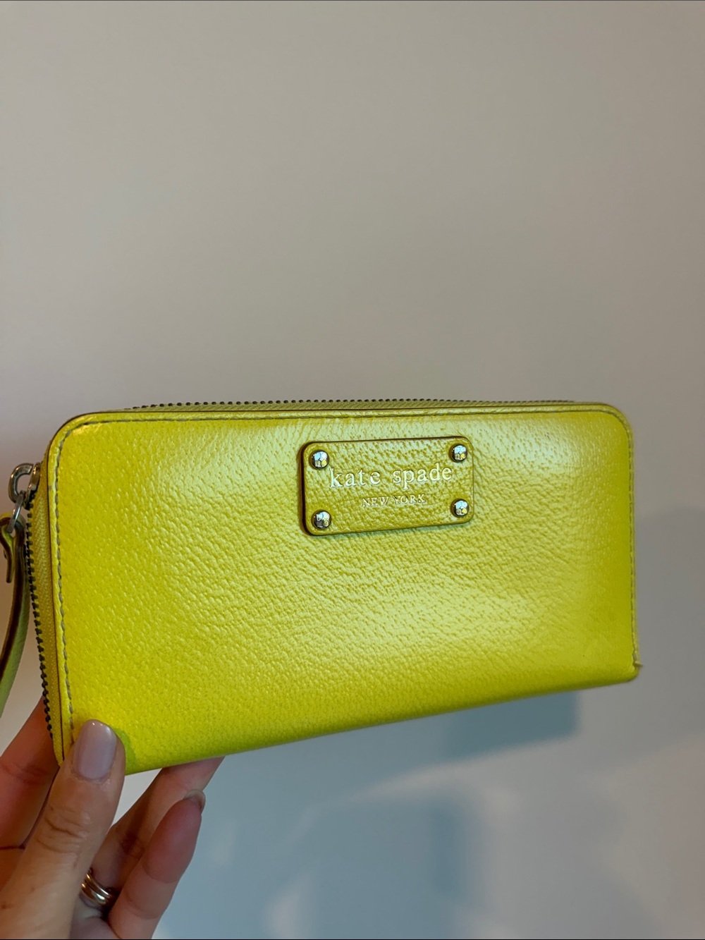 kate spade bright yellow zip-around wallet with gold logo plate